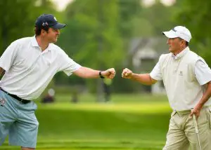 Nathan Smith, left, fist bumps his partner Todd White, right, on the eighth hole during first round of stroke play of the 2016 U.S. Amateur Four-Ball at Winged Foot Golf Club in Mamaroneck, N.Y. on Saturday, May 21, 2016.  (Copyright USGA/Fred Vuich)